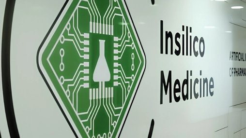 Insilico Medicine logo on a white wall featuring a green diamond with a flask and circuit board design