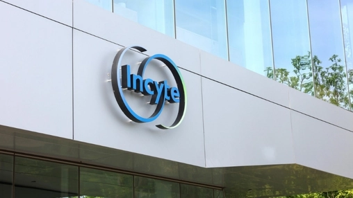 Incyte company logo displayed on the white exterior facade of a modern glass corporate office building